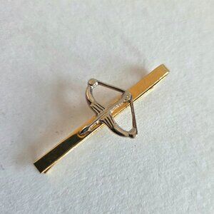 Vintage gold and silver tone metal tie clip bar or money clip with crossbow.